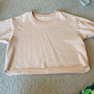 Tularosa medium light pink crop top with silver circles near the sleeves